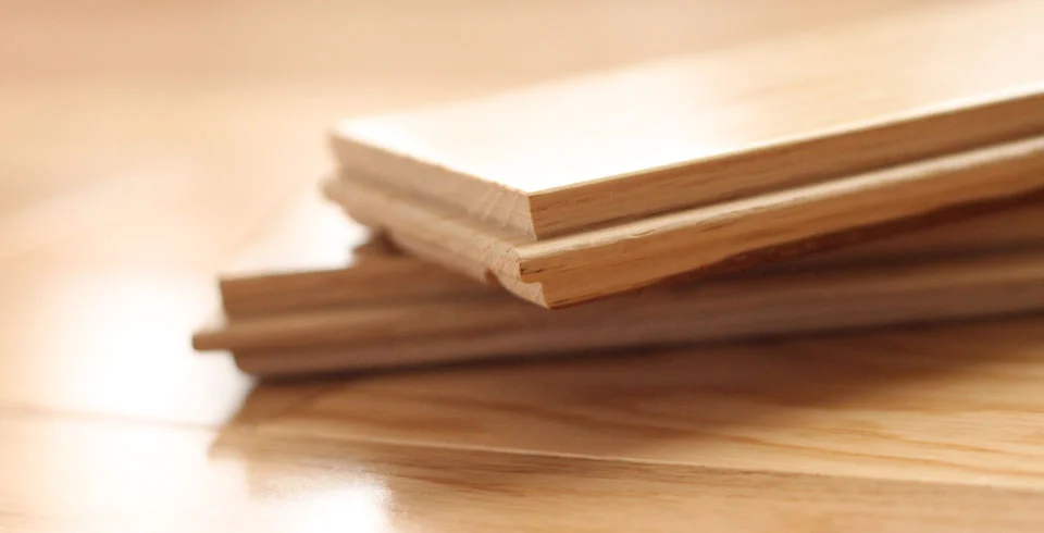 Tongue-and-groove hardwood flooring boards showing the milled profile